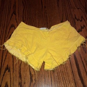 Distressed yellow cropped shorts